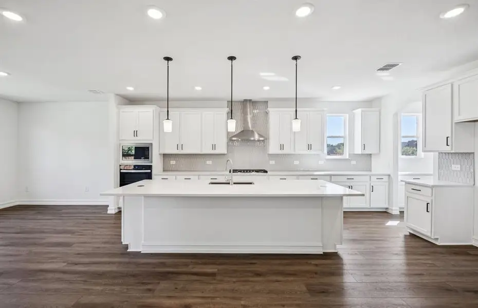 Large island overlooking gathering room and dining areas Large island overlooking gathering room and dining areas