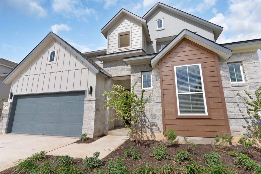 Front exterior of a new home in Santa Rita Ranch, Liberty Hill, TX, highlighting curb appeal (Image 32).