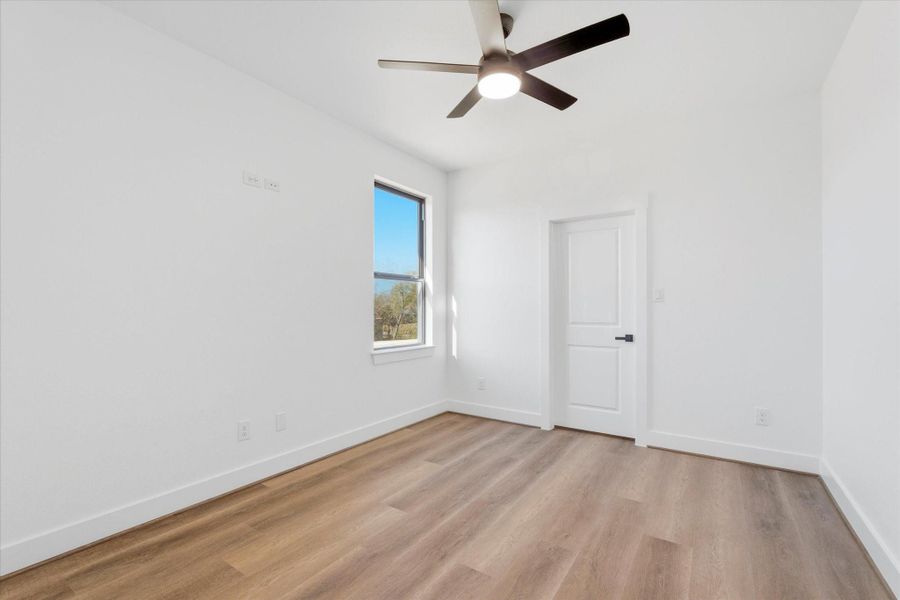 The fourth upstairs bedroom also features a spacious walk-in closet with ample storage.