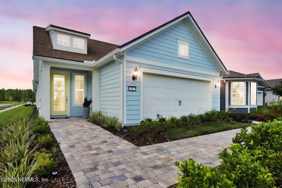 Front exterior of a new home in Summer Bay at Grand Oaks, St. Augustine, FL, highlighting curb appeal (Image 20).