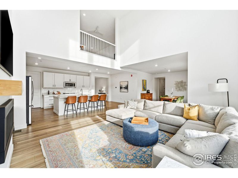 Wide-angle view showing the scale, ceiling height, and natural connection between spaces.