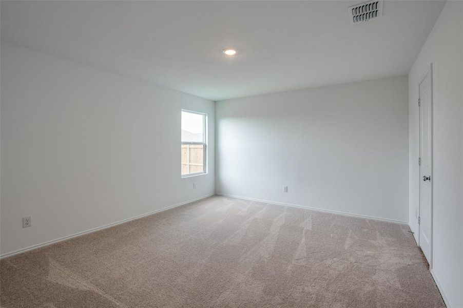 Unfurnished room featuring light colored carpet