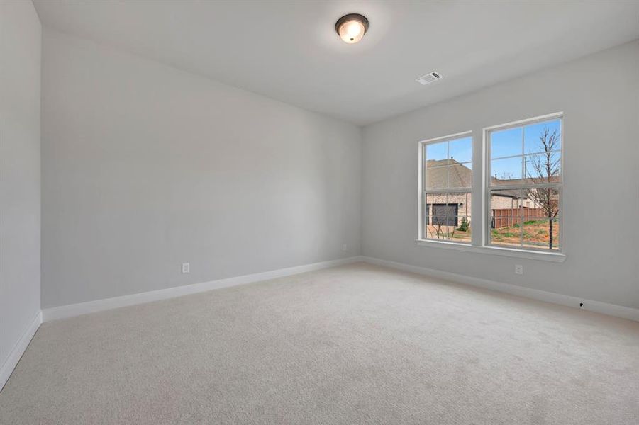 Empty room featuring carpet floors and baseboards
