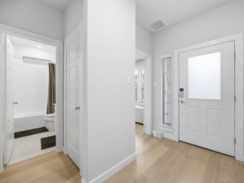 Entryway with light wood finished floors and baseboards