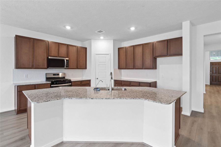 Thoughtfully designed as the true heart of the home, this kitchen serves as a warm and inviting centerpiece for both daily living and effortless entertaining.