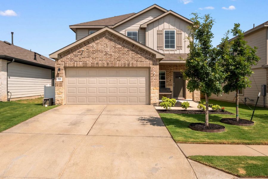 A well-kept front yard and brick facade enhance this charming suburban residence. A well-kept front yard and brick facade enhance this charming suburban residence.