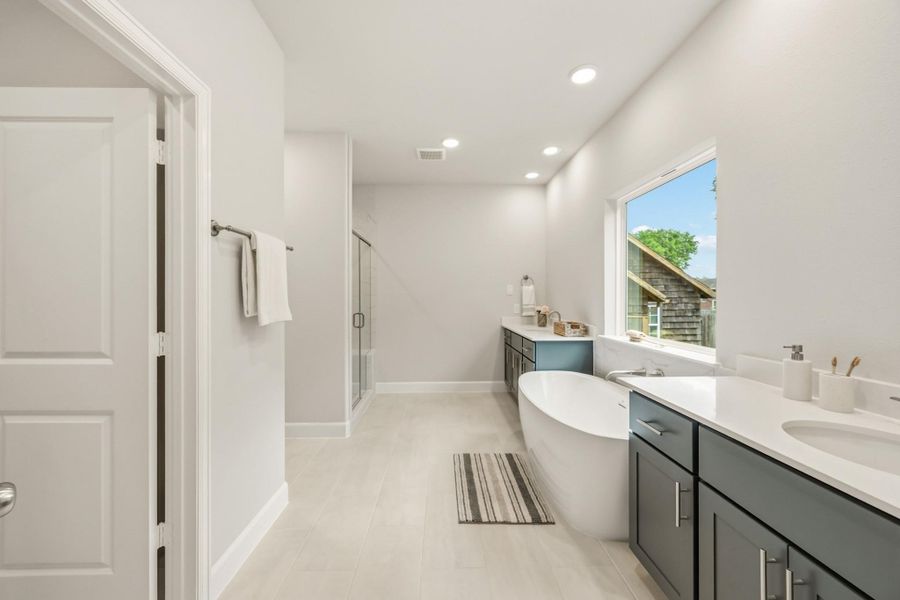 A large, step-in shower with bench seating and a separate water closet redefine luxury, making every morning a spa-like experience. A large, step-in shower with bench seating and a separate water closet redefine luxury, making every morning a spa-like experience.