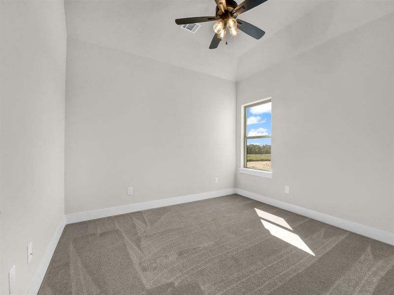 Spare room featuring carpet floors and ceiling fan