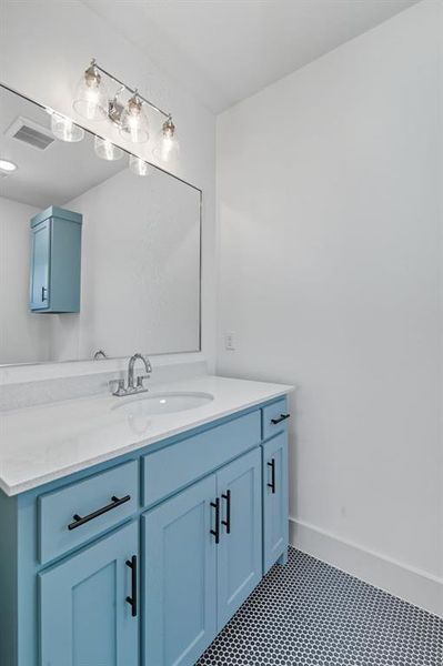 Bathroom with vanity and dark tile patterned floors Bathroom with vanity and dark tile patterned floors