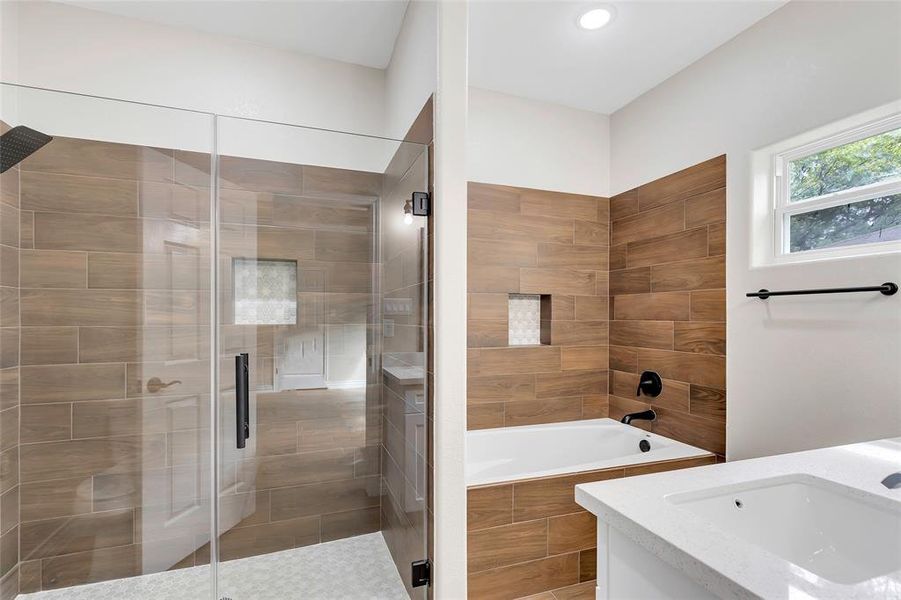 Primary bath with soaking tub and large walk-in shower.