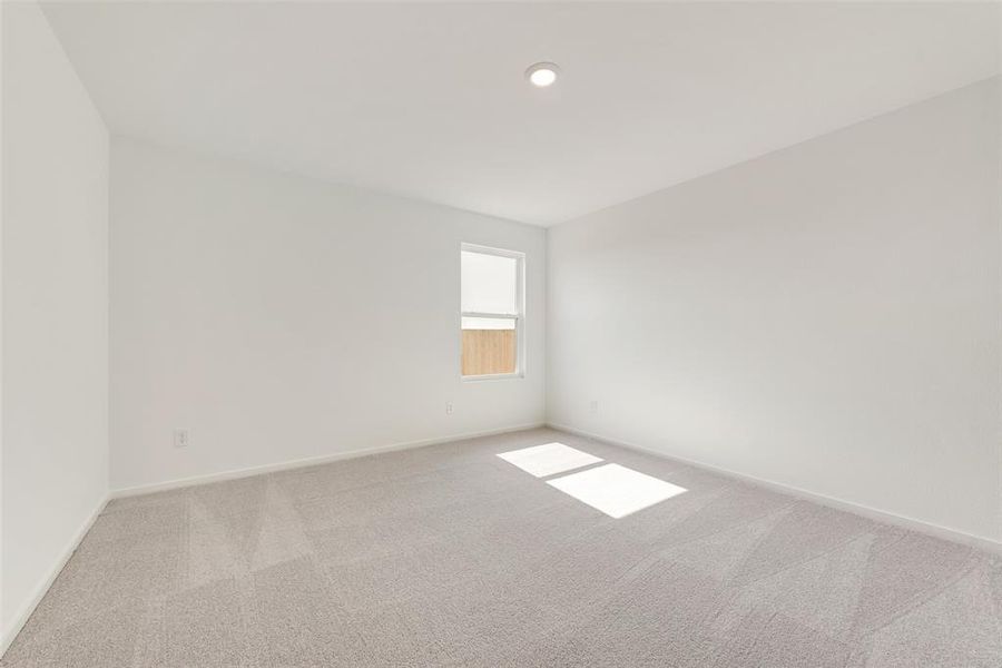Carpeted empty room featuring baseboards and recessed lighting