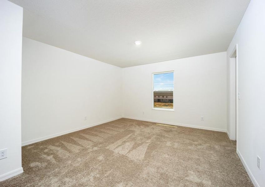 A large bedroom with lush carpet