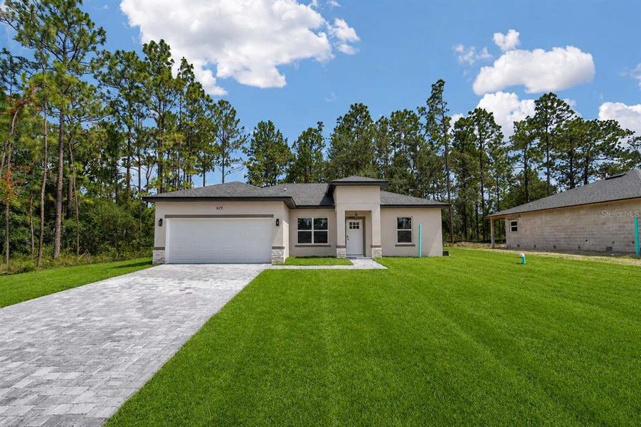 Front exterior of a new home in , Citrus Springs, FL, highlighting curb appeal (Image 17). Front exterior of a new home in , Citrus Springs, FL, highlighting curb appeal (Image 17).