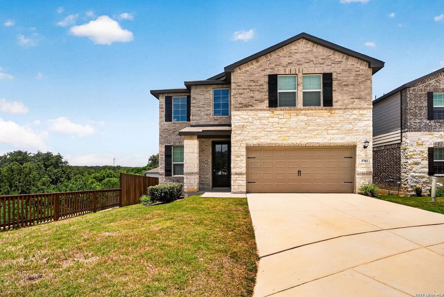 Front exterior of a new home in Thomas Pond, San Antonio, TX, highlighting curb appeal (Image 26).