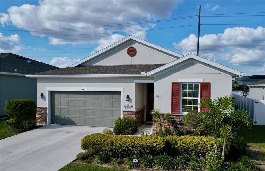 Front exterior of a new home in Seasons at Heritage Square, Haines City, FL, highlighting curb appeal (Image 25). Front exterior of a new home in Seasons at Heritage Square, Haines City, FL, highlighting curb appeal (Image 25).