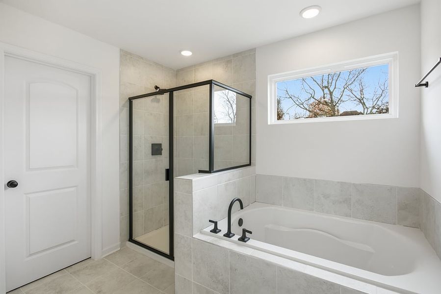 A bathroom with a tub and shower.
