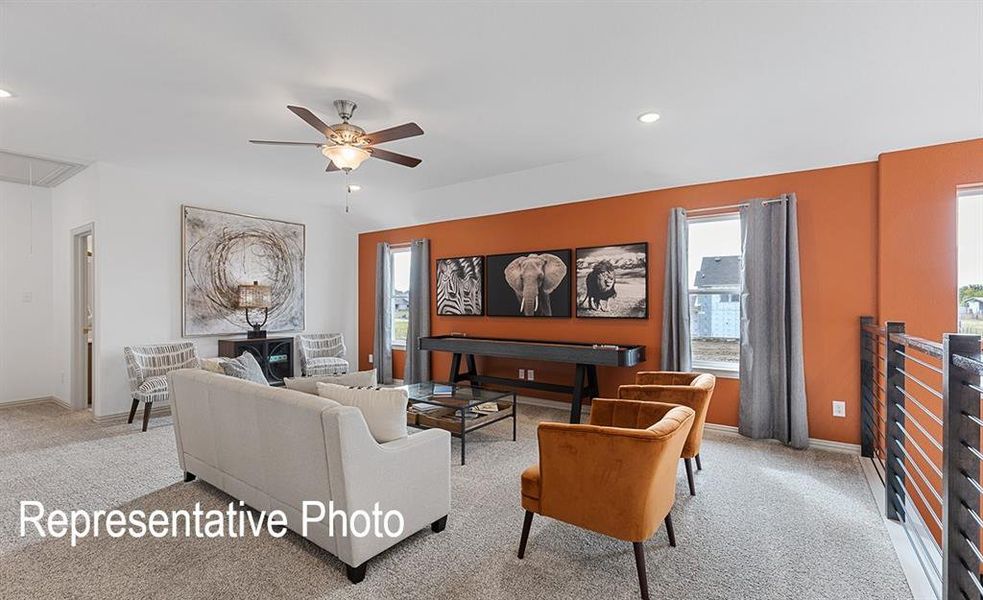 Carpeted living room with ceiling fan