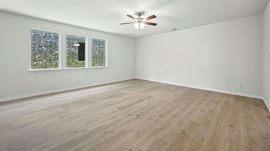 Spare room with light wood-style floors and a ceiling fan Spare room with light wood-style floors and a ceiling fan