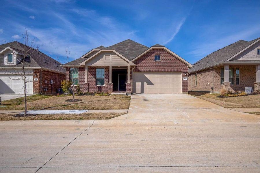 View of front of home featuring brick siding, concrete driveway, covered porch, and a garage View of front of home featuring brick siding, concrete driveway, covered porch, and a garage