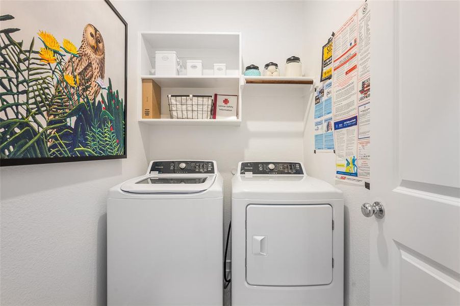 Laundry room with washer and clothes dryer