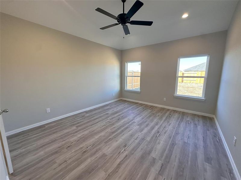 Unfurnished room with ceiling fan and hardwood / wood-style flooring