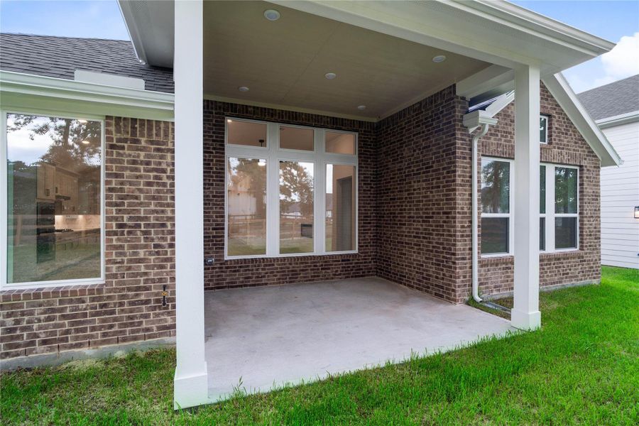 Exterior details and patio area of a home in Timber Hollow, Magnolia (Image 30).
