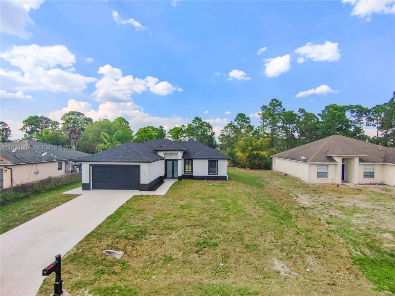 Front exterior of a new home in , Lehigh Acres, FL, highlighting curb appeal (Image 33). Front exterior of a new home in , Lehigh Acres, FL, highlighting curb appeal (Image 33).