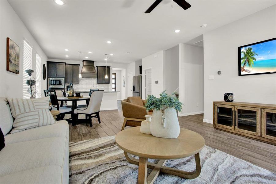 Living room with hardwood / wood-style floors and ceiling fan