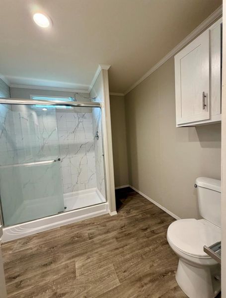 Contemporary bathroom featuring a walk-in shower with clear glass enclosure, marble-look tile surround, and a white shower pan