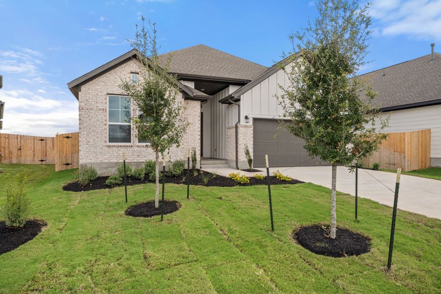 Front exterior of a new home in Lagos Reserve, Manor, TX, highlighting curb appeal (Image 24).