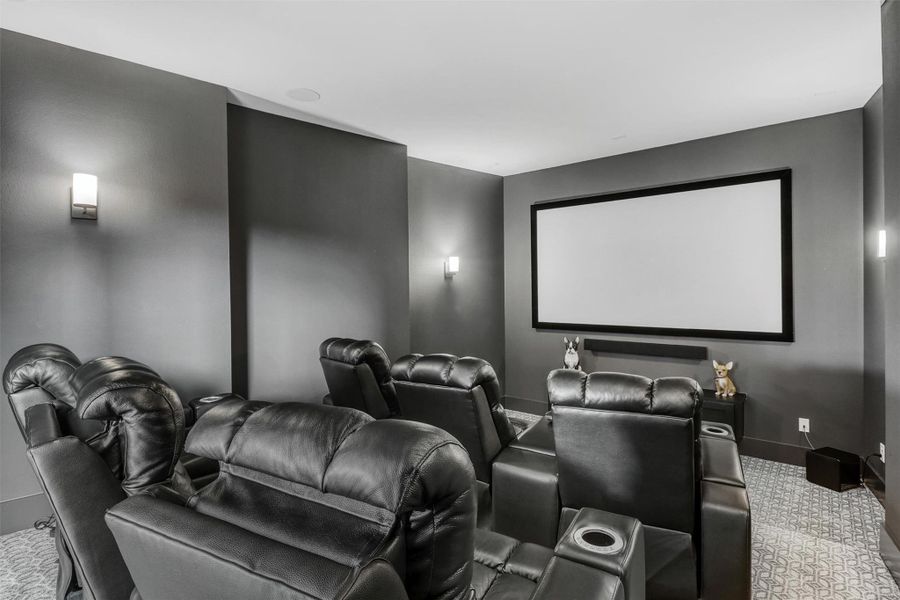 Media Room is on the first floor and features tiered flooring, custom carpeting, built-in sconces, wired for projector and sound, right off the game room, and just steps from the backyard entertainment.