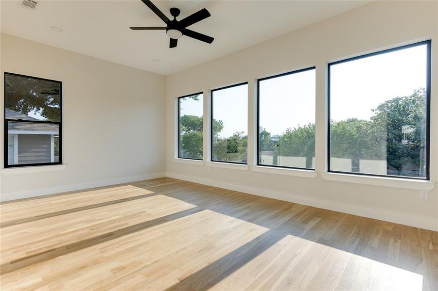 Empty room featuring ceiling fan and light hardwood / wood-style floors