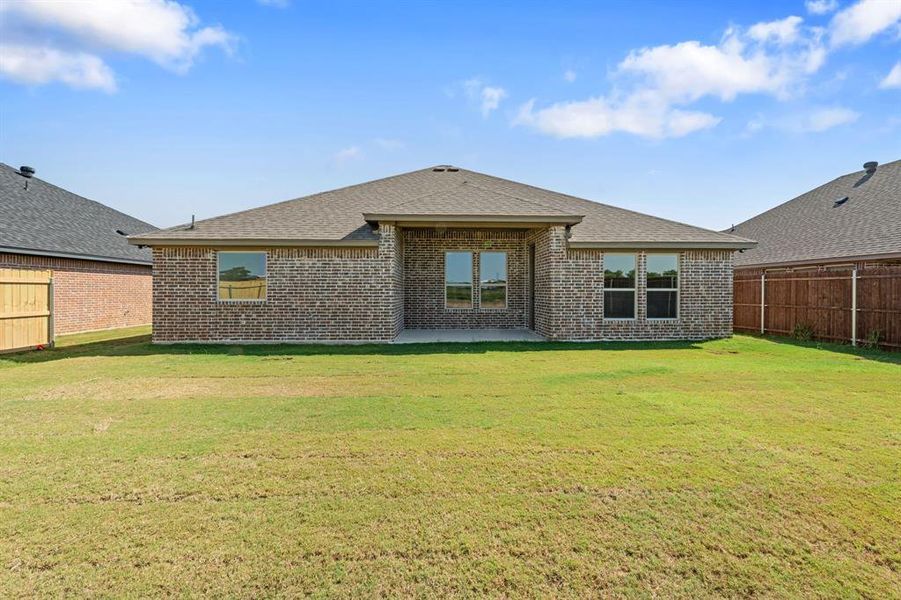 Rear view of property featuring a fenced backyard, a patio area, brick siding, and roof with shingles Rear view of property featuring a fenced backyard, a patio area, brick siding, and roof with shingles