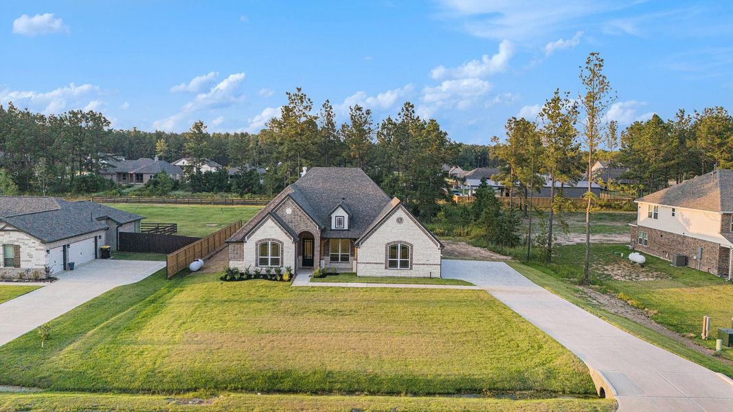 Front exterior of a new home in Deer Pines, Conroe, TX, highlighting curb appeal (Image 2). Front exterior of a new home in Deer Pines, Conroe, TX, highlighting curb appeal (Image 2).