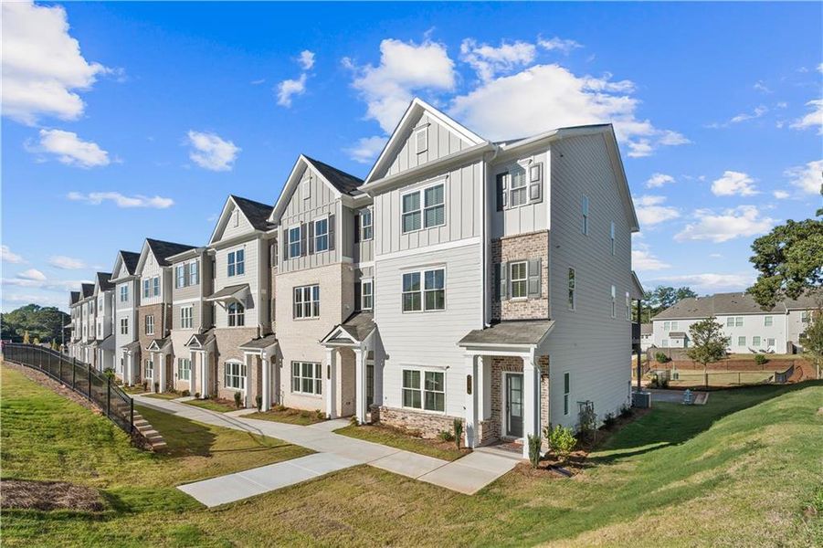 Front exterior of a new home in East Park Village, Kennesaw, GA, highlighting curb appeal (Image 1). Front exterior of a new home in East Park Village, Kennesaw, GA, highlighting curb appeal (Image 1).