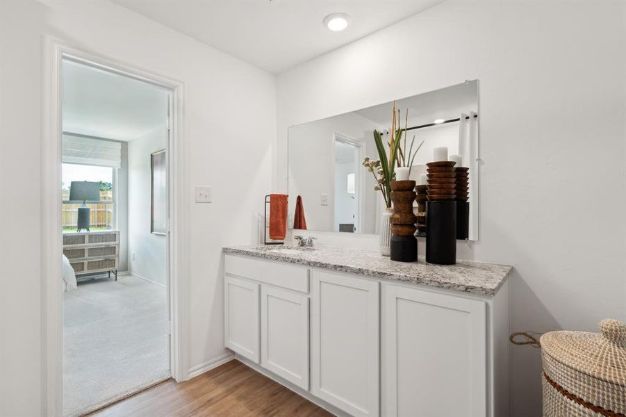 Bathroom with hardwood / wood-style floors and vanity