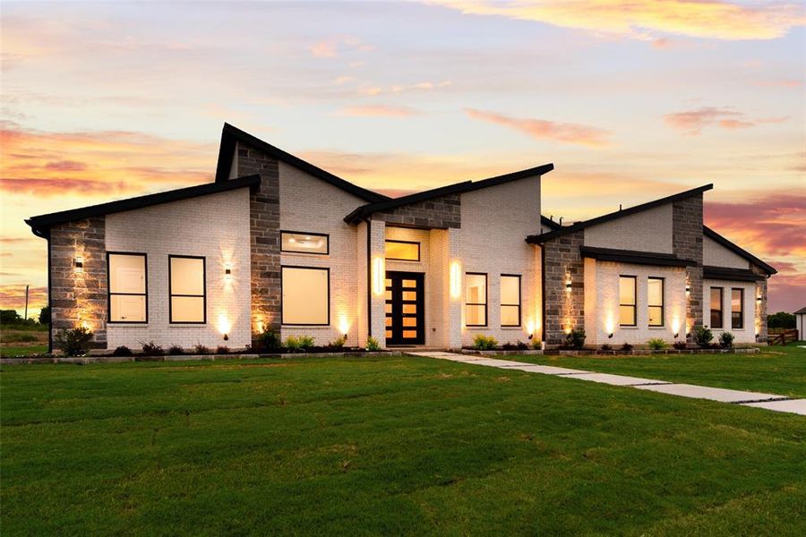 Contemporary house with brick siding and a front yard Contemporary house with brick siding and a front yard