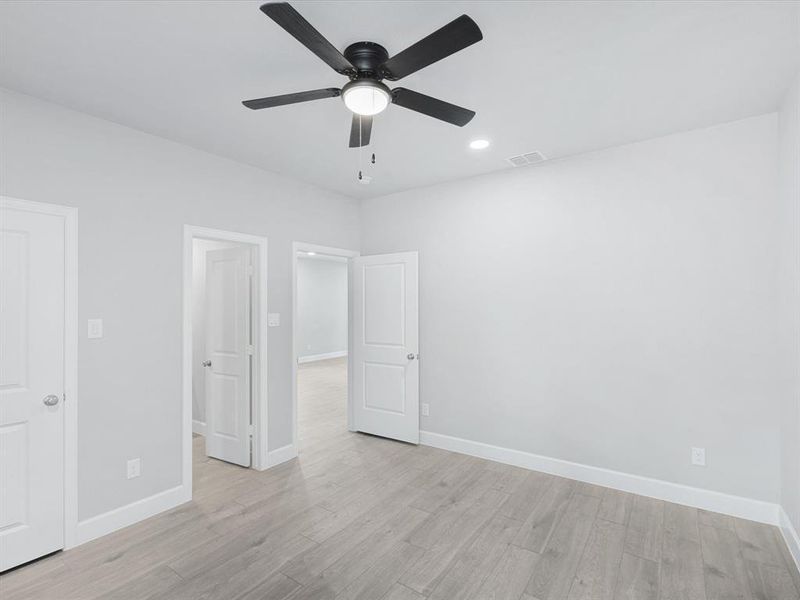 Unfurnished bedroom with light wood-type flooring, ceiling fan, and recessed lighting