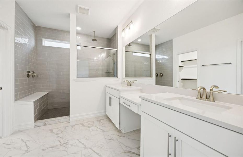 Owner's bath designed with a double vanity and oversized shower  *Real home pictured