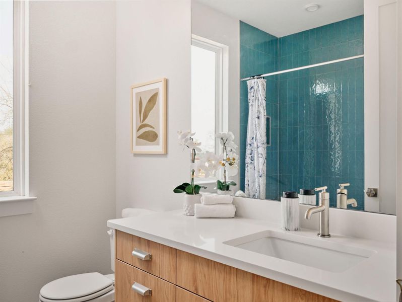 Bathroom featuring vanity and tiled shower