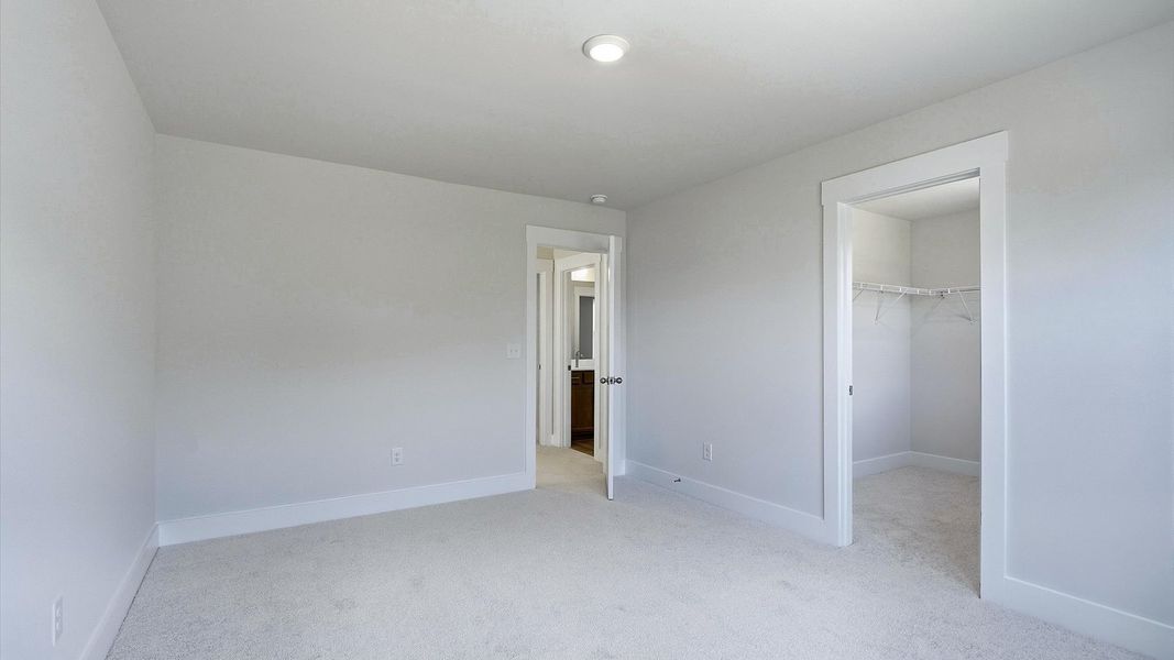 Memorable space offering plush carpet underfoot and a thoughtfully planned walk-in closet by DRB Homes Memorable space offering plush carpet underfoot and a thoughtfully planned walk-in closet by DRB Homes