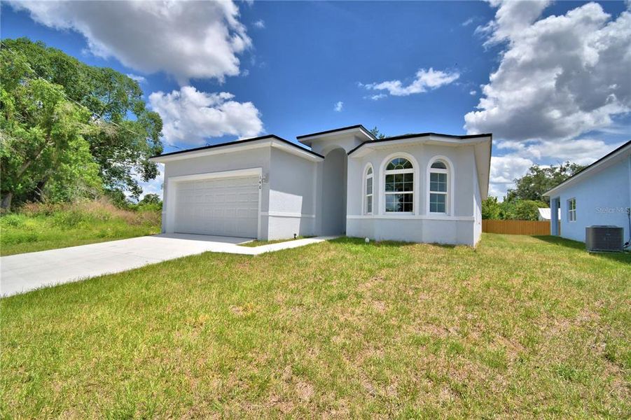 Front exterior of a new home in , Winter Haven, FL, highlighting curb appeal (Image 21).