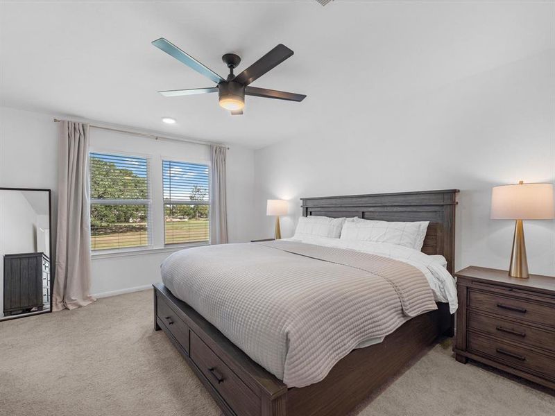 The primary bedroom is generously sized, creating a tranquil and spacious retreat that offers ample room for relaxation. Featuring plush carpet, high ceilings, fresh paint, and large windows that lets in natural lighting throughout the day.