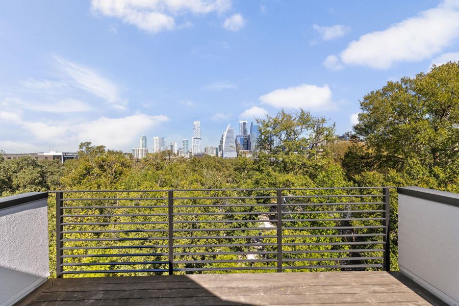 Wooden deck featuring a view of skyline Wooden deck featuring a view of skyline
