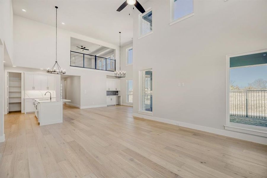 Family room looking to the kitchen and dining space with soaring ceilings