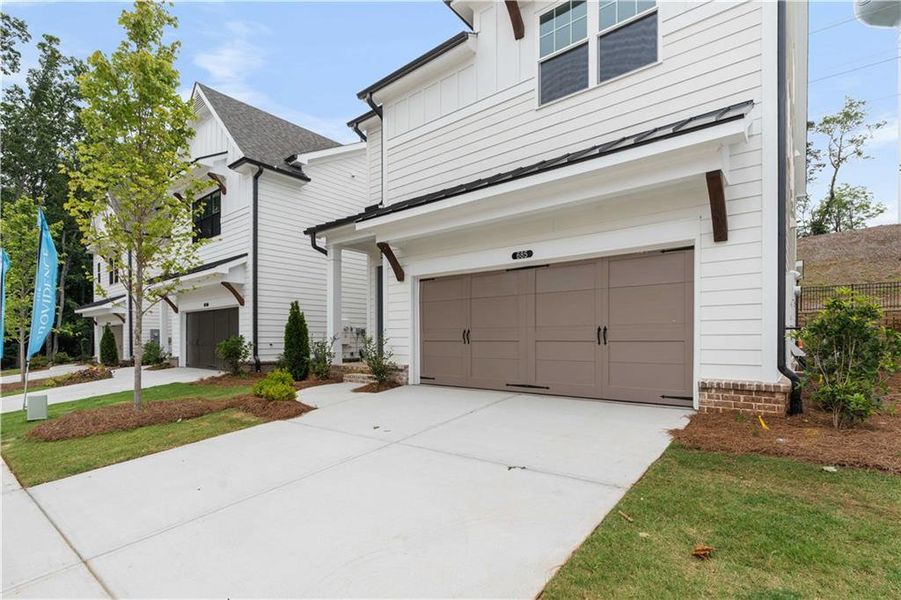 Front exterior of a new home in Palisades Single Family, Cumming, GA, highlighting curb appeal (Image 28).