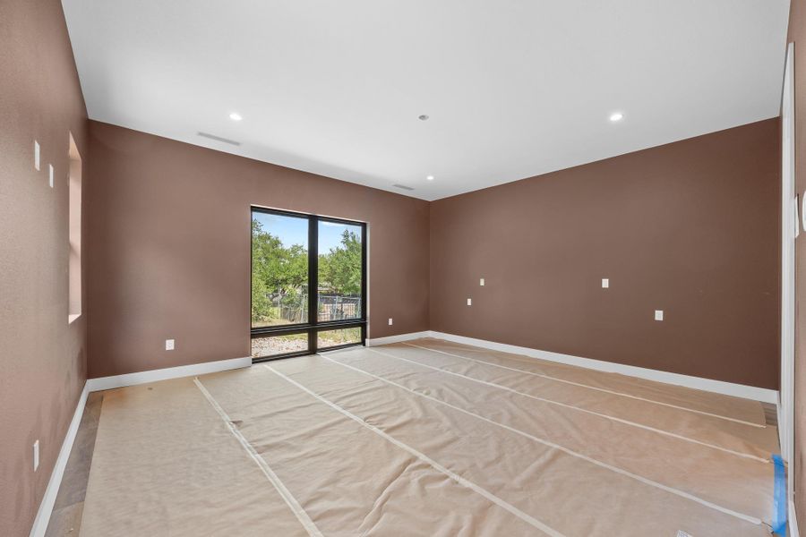 Spacious interior room with brown walls and a high white ceiling