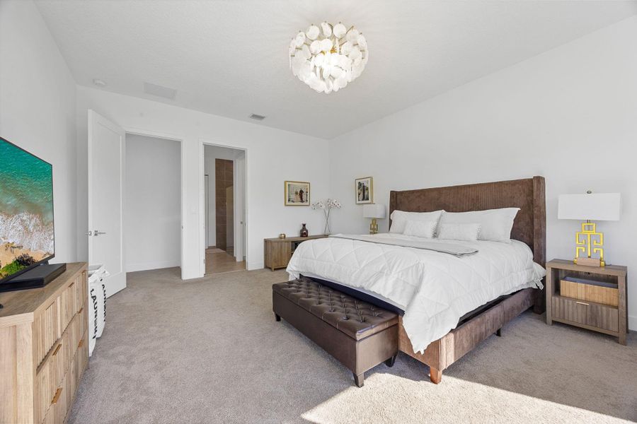 Bedroom with carpet floors and a chandelier