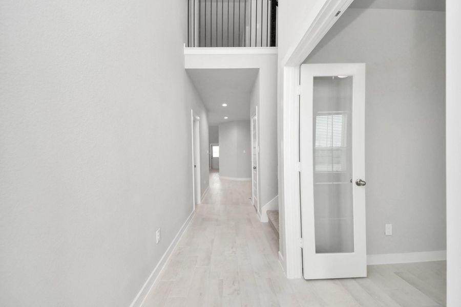 As you step into the threshold of this luxurious home, you'll soon be welcomed by an elegant glass door (to be installed). Inside, soaring ceilings amplify the spaciousness, while the refined wood-look tile flooring and oversized baseboards exude sophistication and charm. Sample photo of completed home with similar floor plan. Actual colors and selections may vary. As you step into the threshold of this luxurious home, you'll soon be welcomed by an elegant glass door (to be installed). Inside, soaring ceilings amplify the spaciousness, while the refined wood-look tile flooring and oversized baseboards exude sophistication and charm. Sample photo of completed home with similar floor plan. Actual colors and selections may vary.