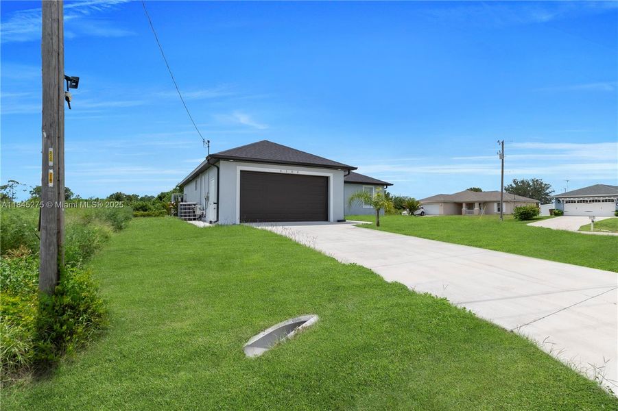 Front exterior of a new home in , Lehigh Acres, FL, highlighting curb appeal (Image 20).